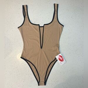 New! Front zip bodysuit in tan with contrast black, ribbed, new with tags!